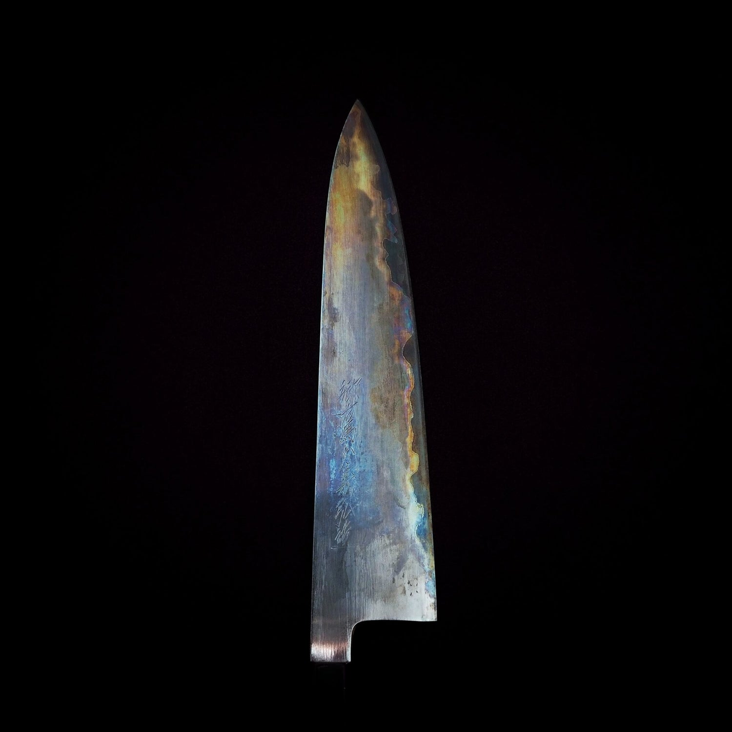 Top view of a Yoshikazu Tanaka gyuto knife showing its colorful patina. 