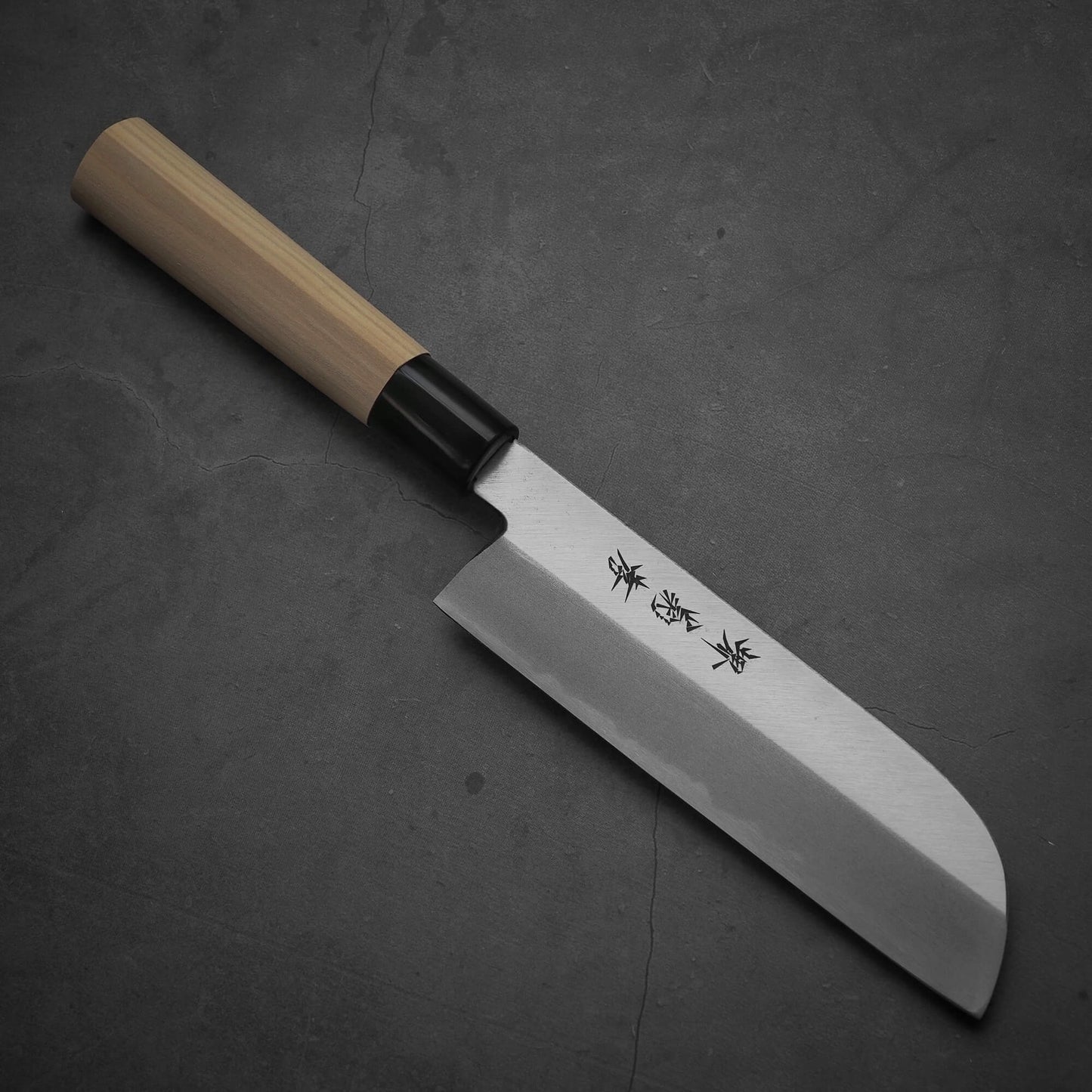 Top view of Sakai Takayuki shirogami#3 kamagata usuba knife where the pointed tip is facing towards lower right