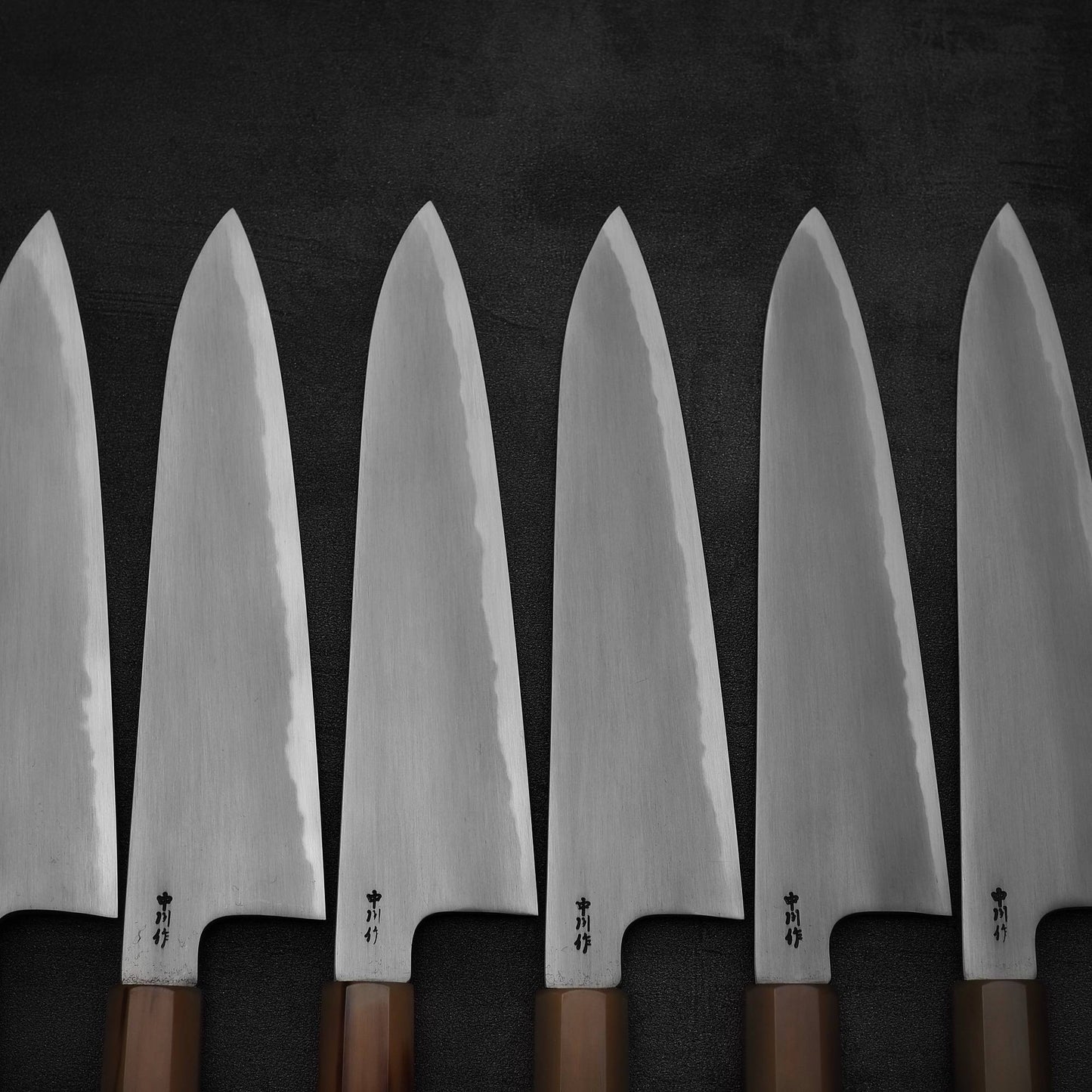 A group photo of multiple Nakagawa bokashi shirogami#1 tall gyuto knives