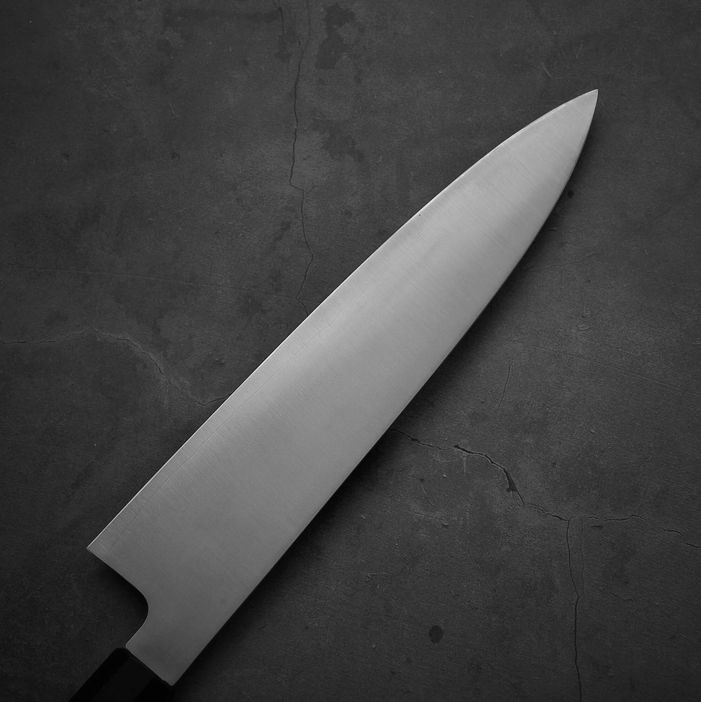 Top view of the blade of Sukenari XEOS gyuto 240mm. Image shows left side of the blade