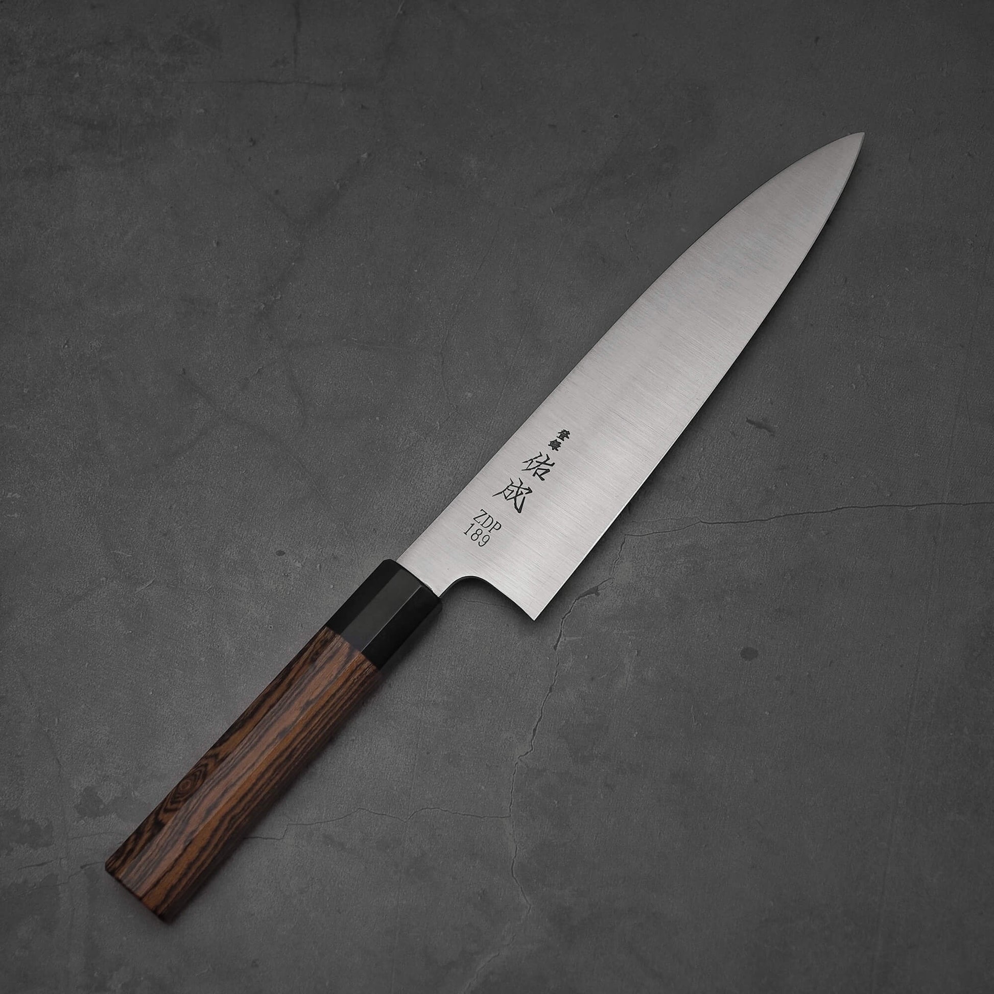 Top view of 210mm Sukenari ZDP189 gyuto where pointed tip is facing towards the upper right.