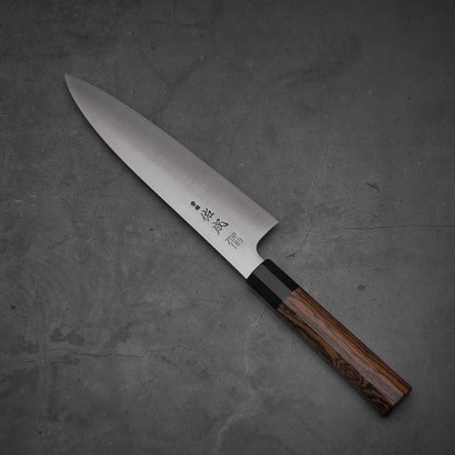 Top view of 210mm Sukenari ZDP189 gyuto knife where the pointed tip is facing towards the upper left.