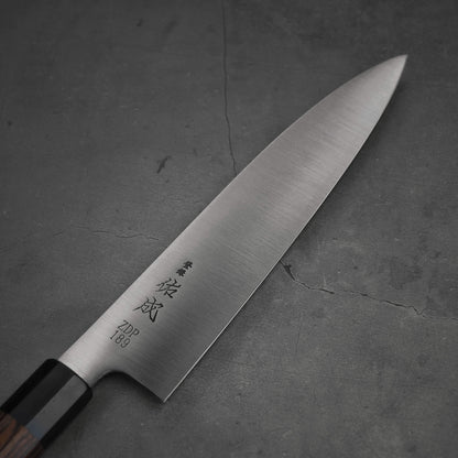 Top view of 210mm Sukenari ZDP189 gyuto knife. Image focuses on the blade only with kanji.