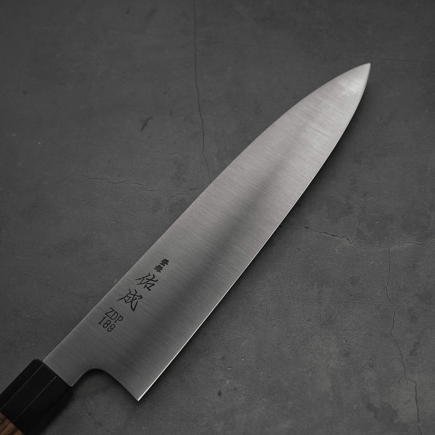 Top view of 240mm Sukenari ZDP189 gyuto knife. Image focuses on the blade only with kanji