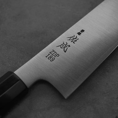 Close up view of a 240mm Sukenari ZDP189 gyuto knife showing the kanji stamp
