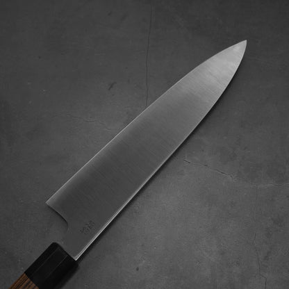 Top view of a 240mm Sukenari ZDP189 gyuto knife. Image focuses on the back side of the knife.
