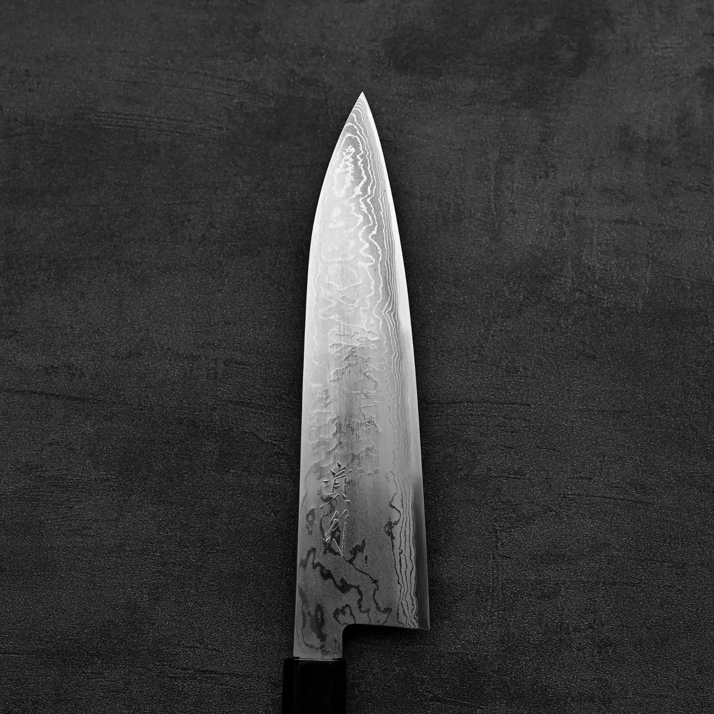 Close up view of the blade of Takayuki Iwai aogami#2 damascus 210mm gyuto knife showing the front side