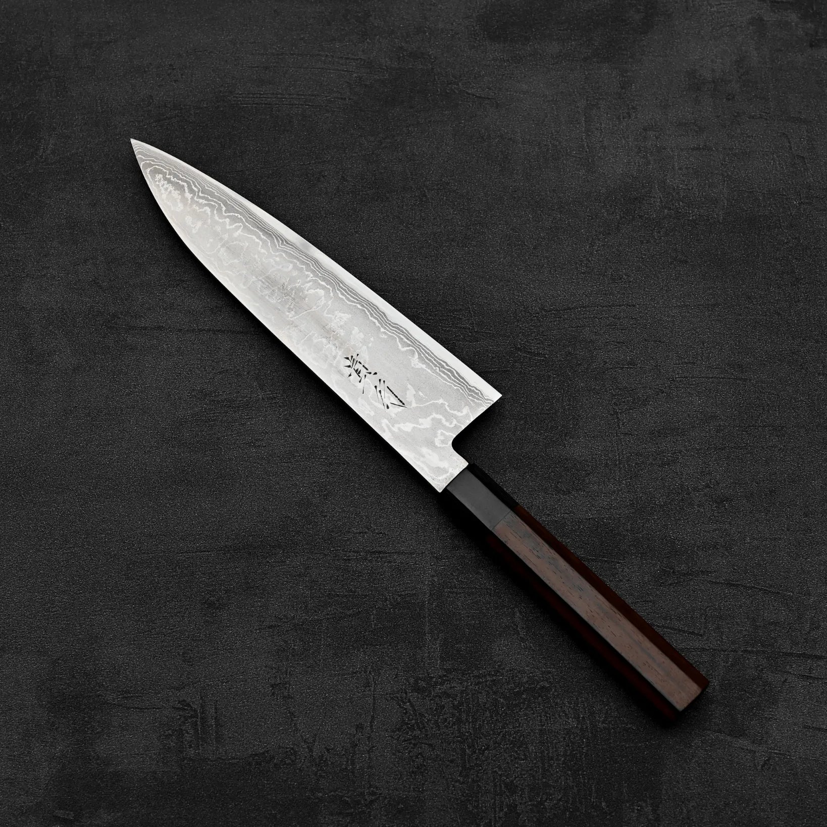 Top down view of Takayuki Iwai aogami#2 damascus 210mm gyuto knife in diagonal position