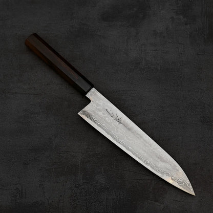 Top down view of Takayuki Iwai aogami#2 damascus 240mm gyuto knife in diagonal position