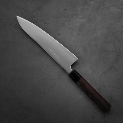 Top down view of Yoshihiro migaki aogami super gyuto. This Japanese chef's knife has an octagonal rosewood handle.