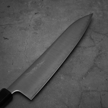 Close up view of Yoshihiro migaki aogami super gyuto. This Japanese chef's knife has an octagonal rosewood handle.