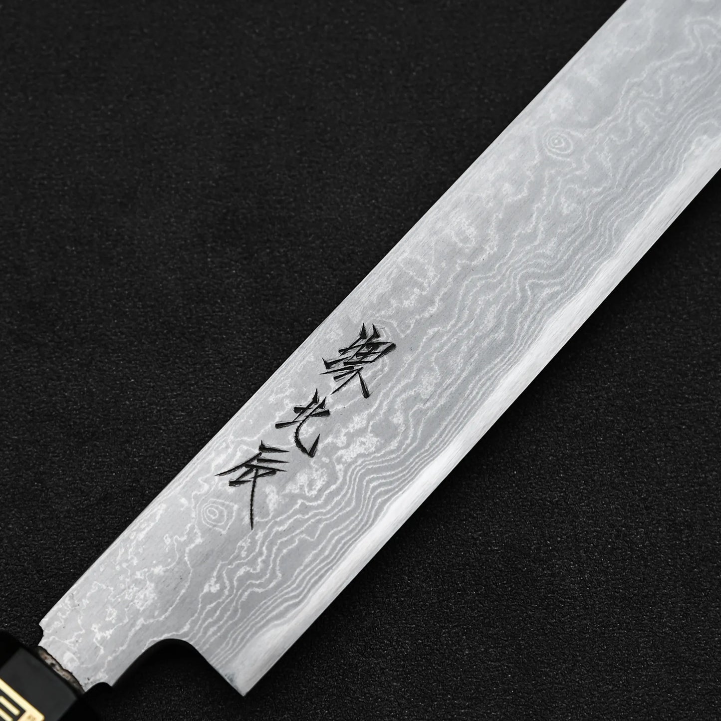 Close up view of the kanji of Yoshikazu Ikeda aogami#1 damascus sakimaru sujihiki knife