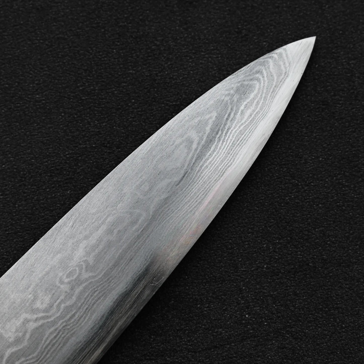 Close up view of the tip area of Yoshikazu Ikeda aogami#1 damascus slim gyuto knife