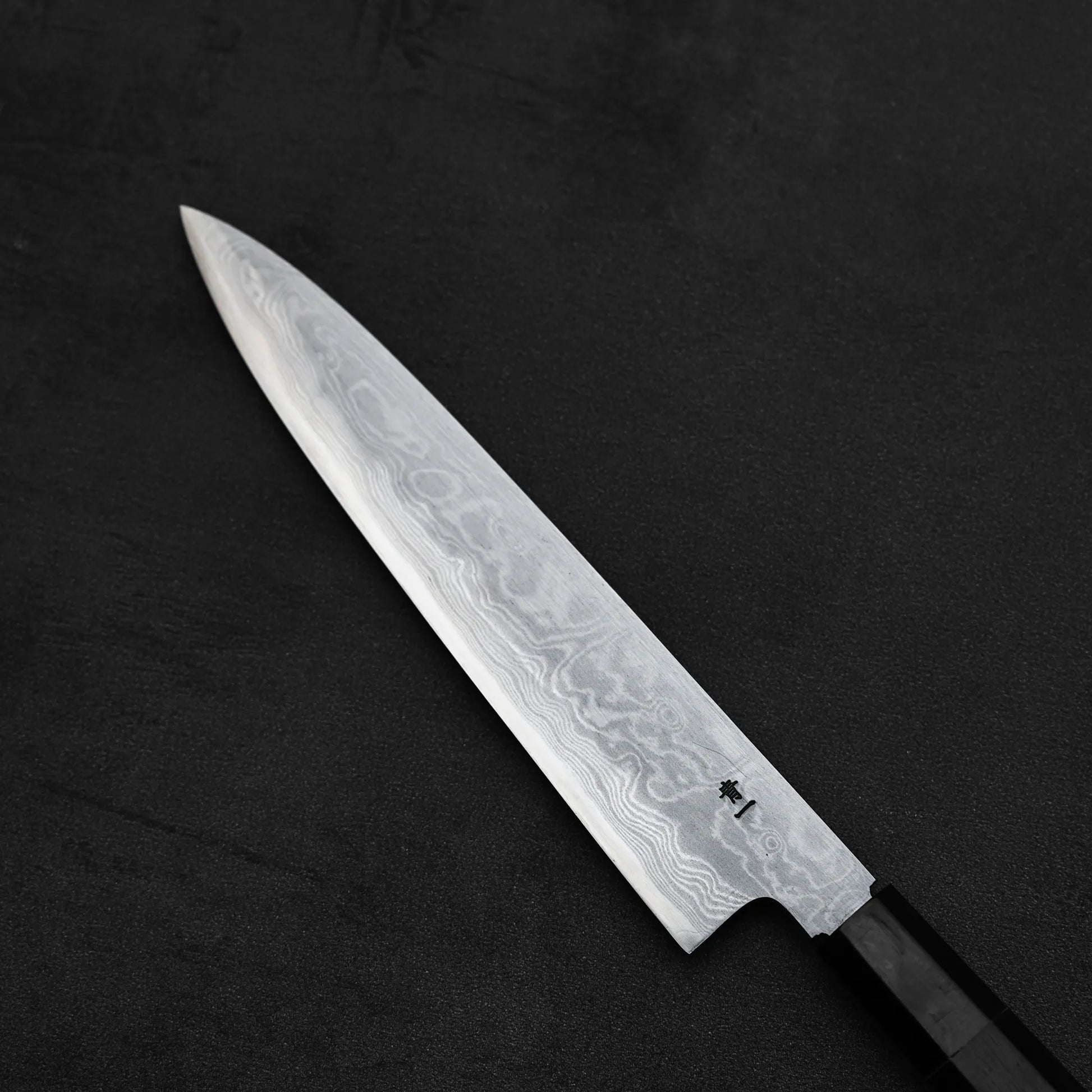 Top down view of the back blade of Yoshikazu Ikeda aogami#1 damascus slim gyuto knife