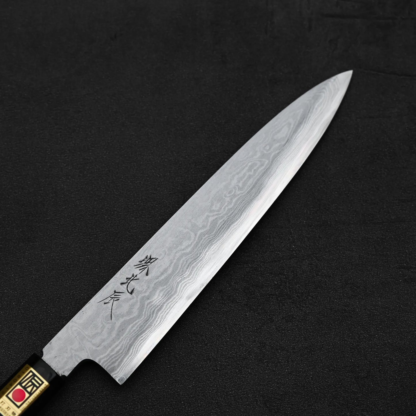 Close up view of the front blade of Yoshikazu Ikeda aogami#1 damascus slim gyuto knife