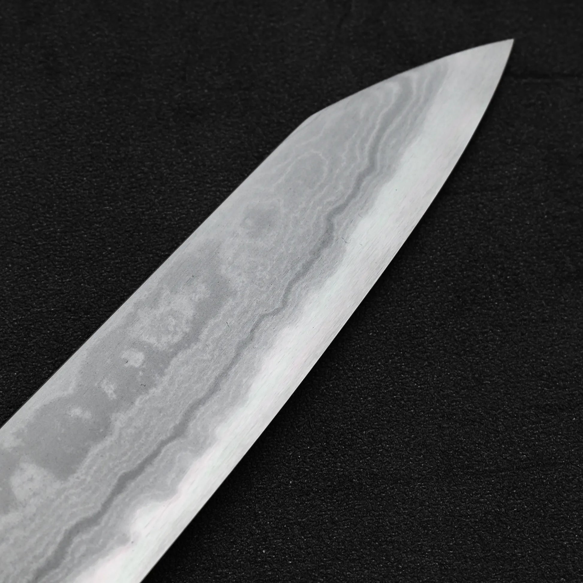 Close up view of the tip area of Yoshikazu Ikeda aogami#1 damascus slim ktip gyuto knife