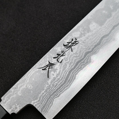 Close up view of the kanji of Yoshikazu Ikeda aogami#1 damascus slim ktip gyuto knife