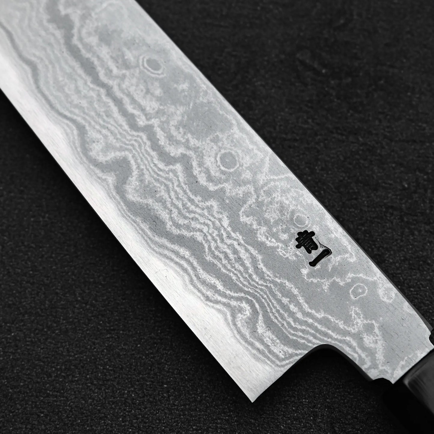 Close up view of the kanji on the back side of Yoshikazu Ikeda aogami#1 damascus slim ktip gyuto knife