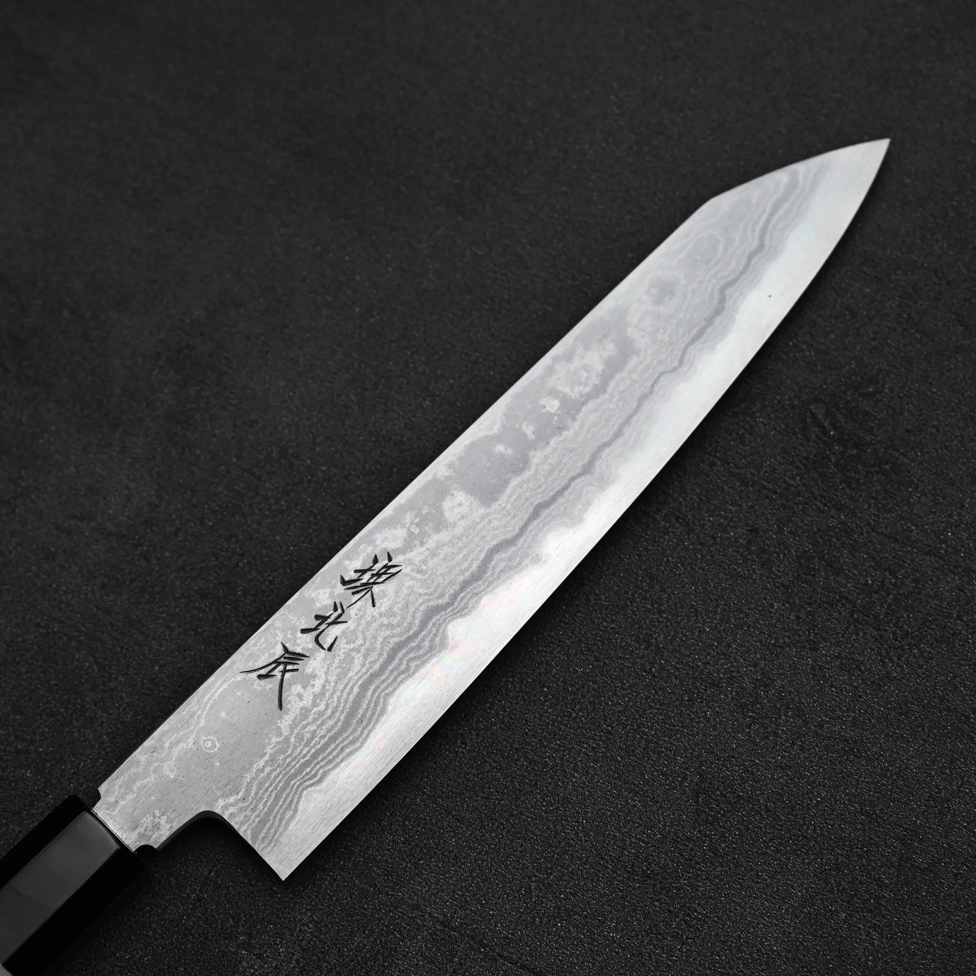 Close up view of Yoshikazu Ikeda aogami#1 damascus slim ktip gyuto knife