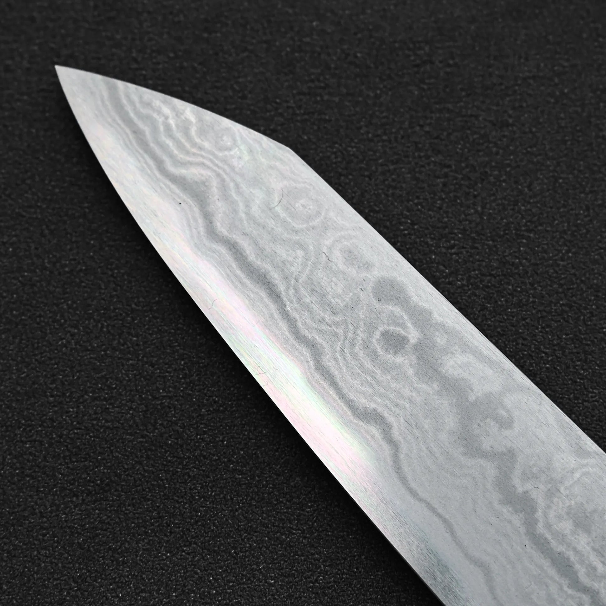 Close up view of the tip area of Yoshikazu Ikeda aogami#1 damascus slim ktip gyuto knife