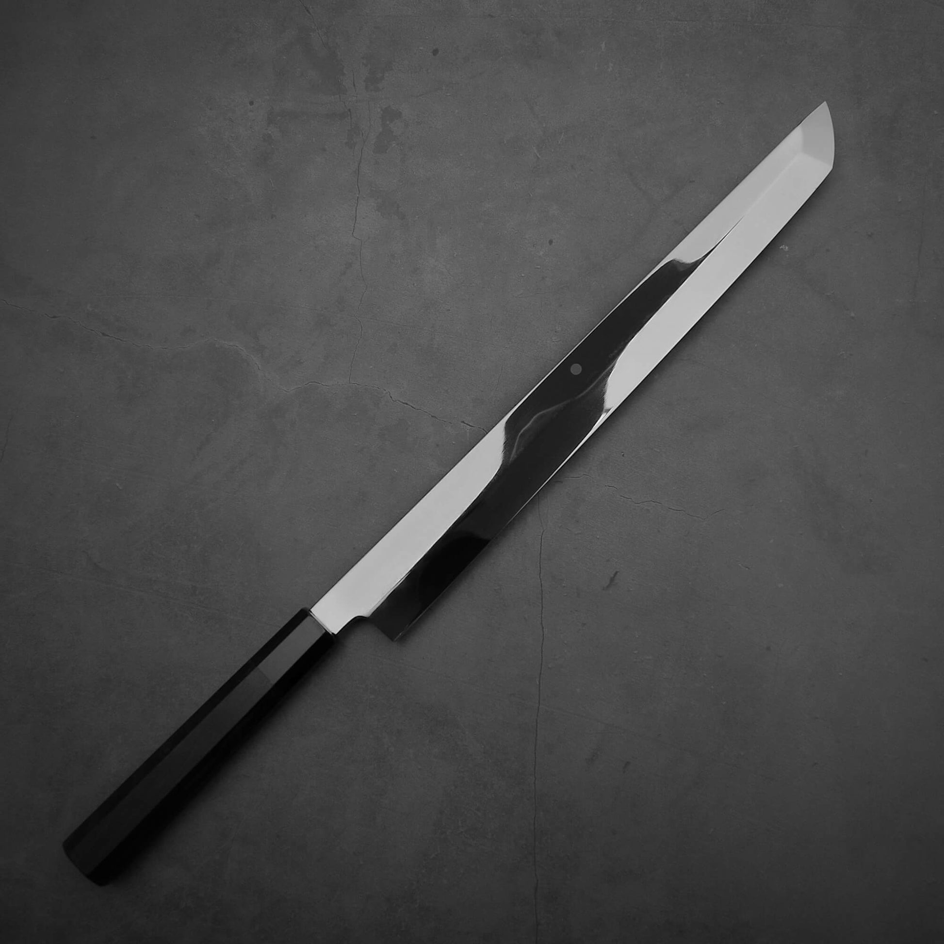 Top down view of the front side of Yoshikazu Ikeda honyaki sakimaru takohiki. This hand-forged Japanese knife is made of shirogami#1 steel.