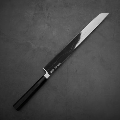 Top down view of the backside of Yoshikazu Ikeda honyaki sakimaru takohiki. This hand-forged Japanese knife is made of shirogami#1 steel.