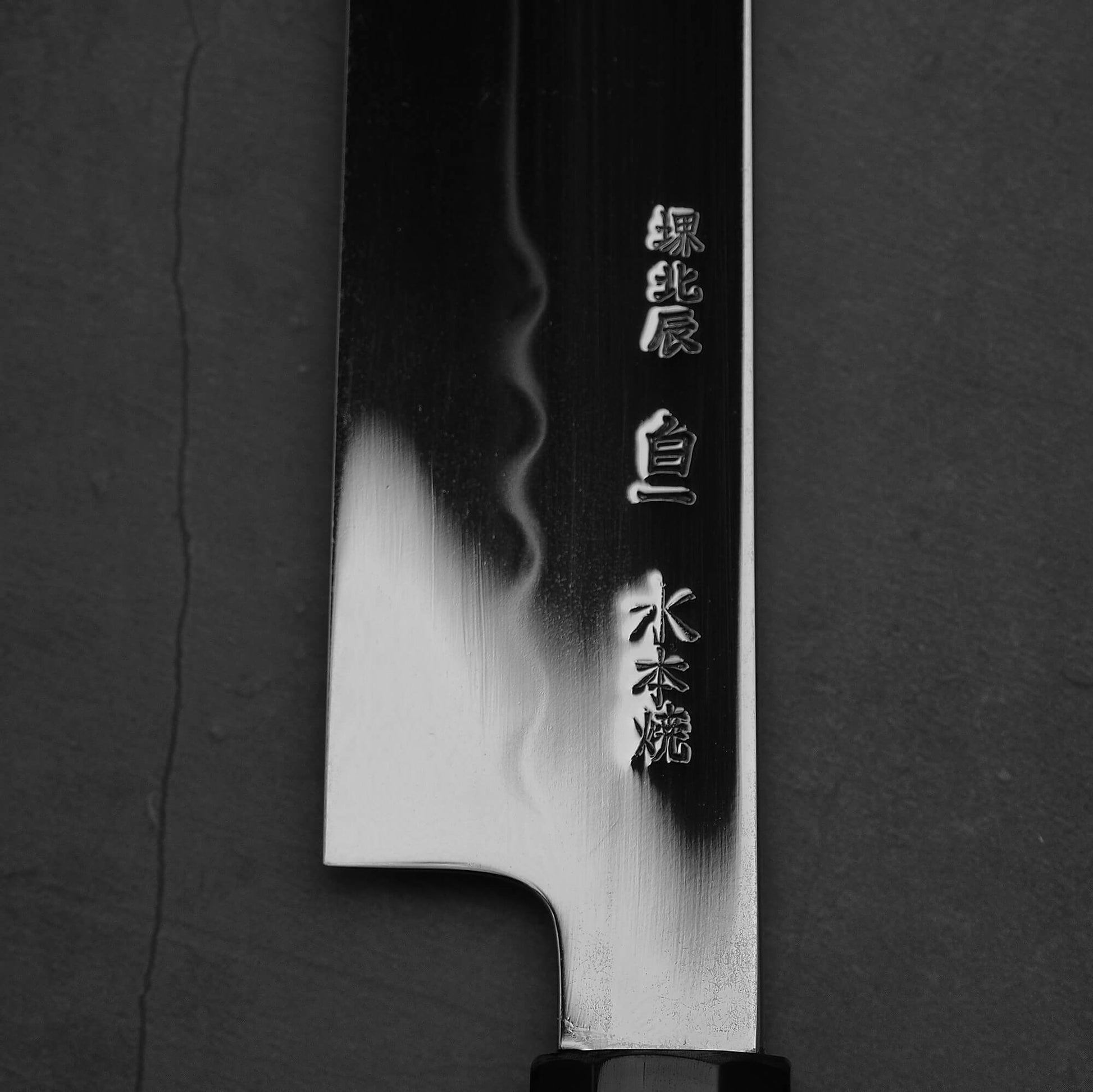 Close up view of the kanji of Yoshikazu Ikeda honyaki sakimaru takohiki. This hand-forged Japanese knife is made of shirogami#1 steel.