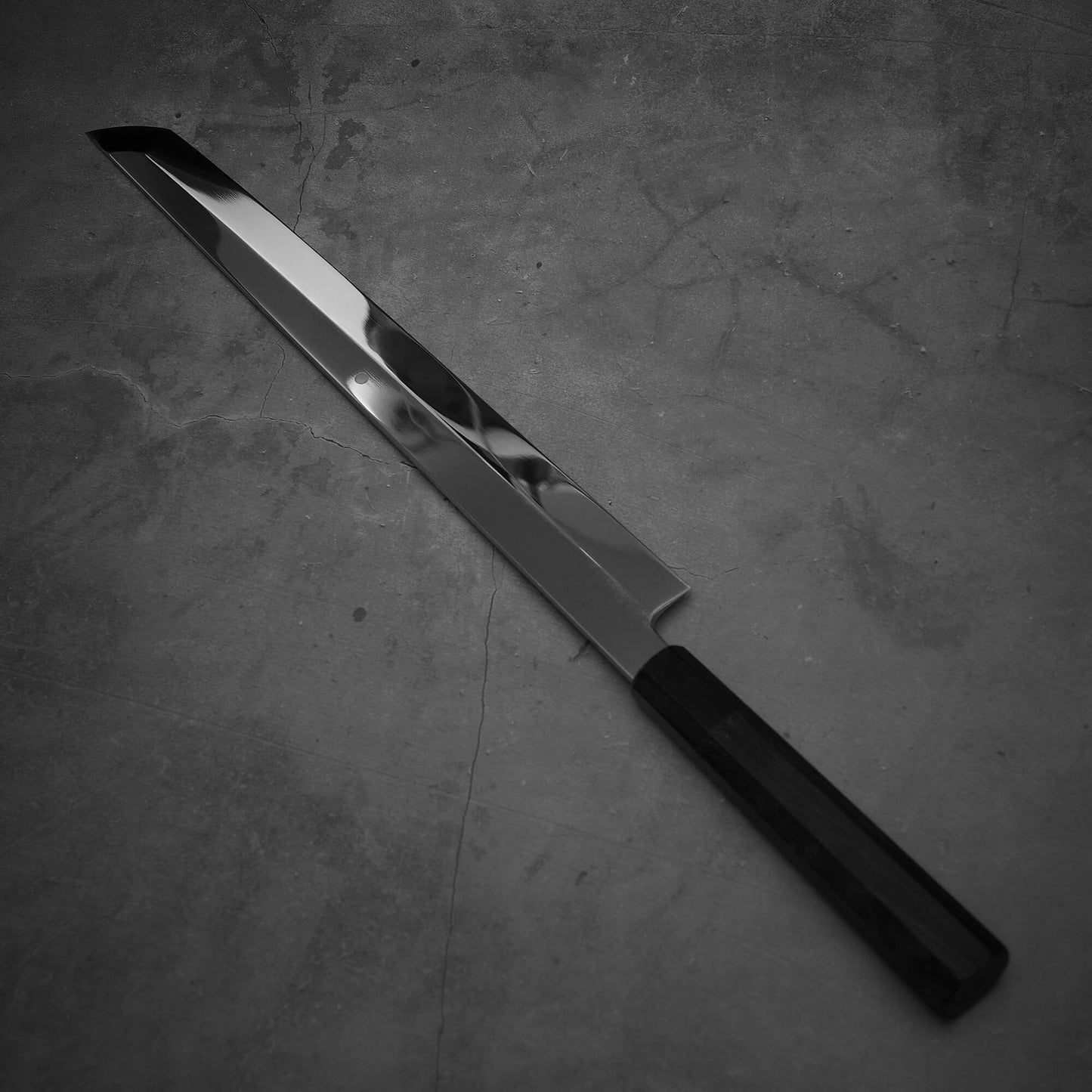 Angled view of Yoshikazu Ikeda honyaki sakimaru takohiki. This hand-forged Japanese knife is made of shirogami#1 steel.