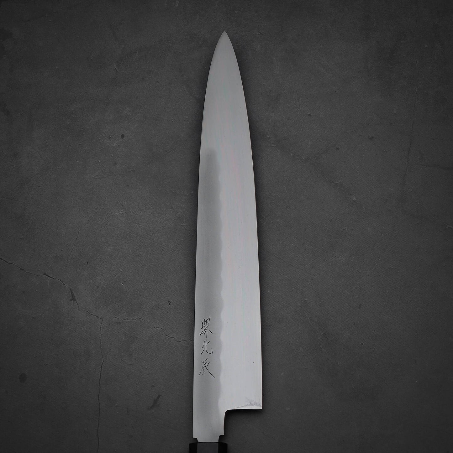 Close up view of Yoshikazu Ikeda honyaki sujihiki. This hand-forged Japanese knife is made of shirogami#3 steel.