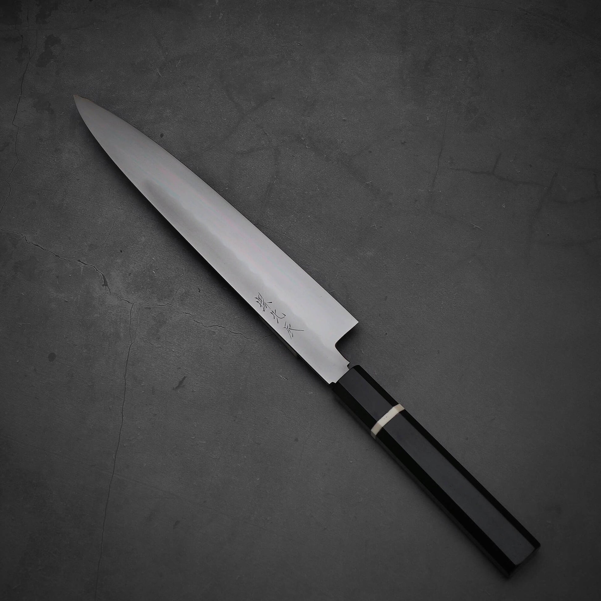 Top down view of Yoshikazu Ikeda honyaki sujihiki. This hand-forged Japanese knife is made of shirogami#3 steel.