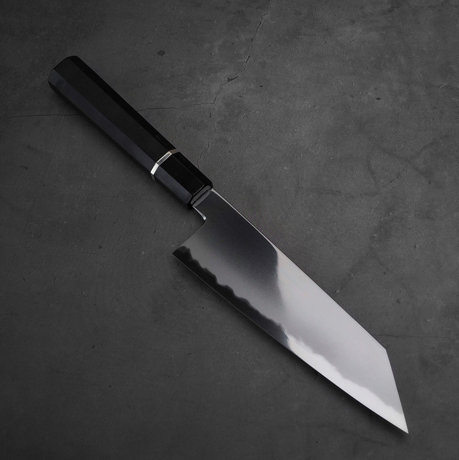 Angled view of Yoshikazu Tanaka AS bunka. This hand-forged Japanese knife is made of aogami super steel.