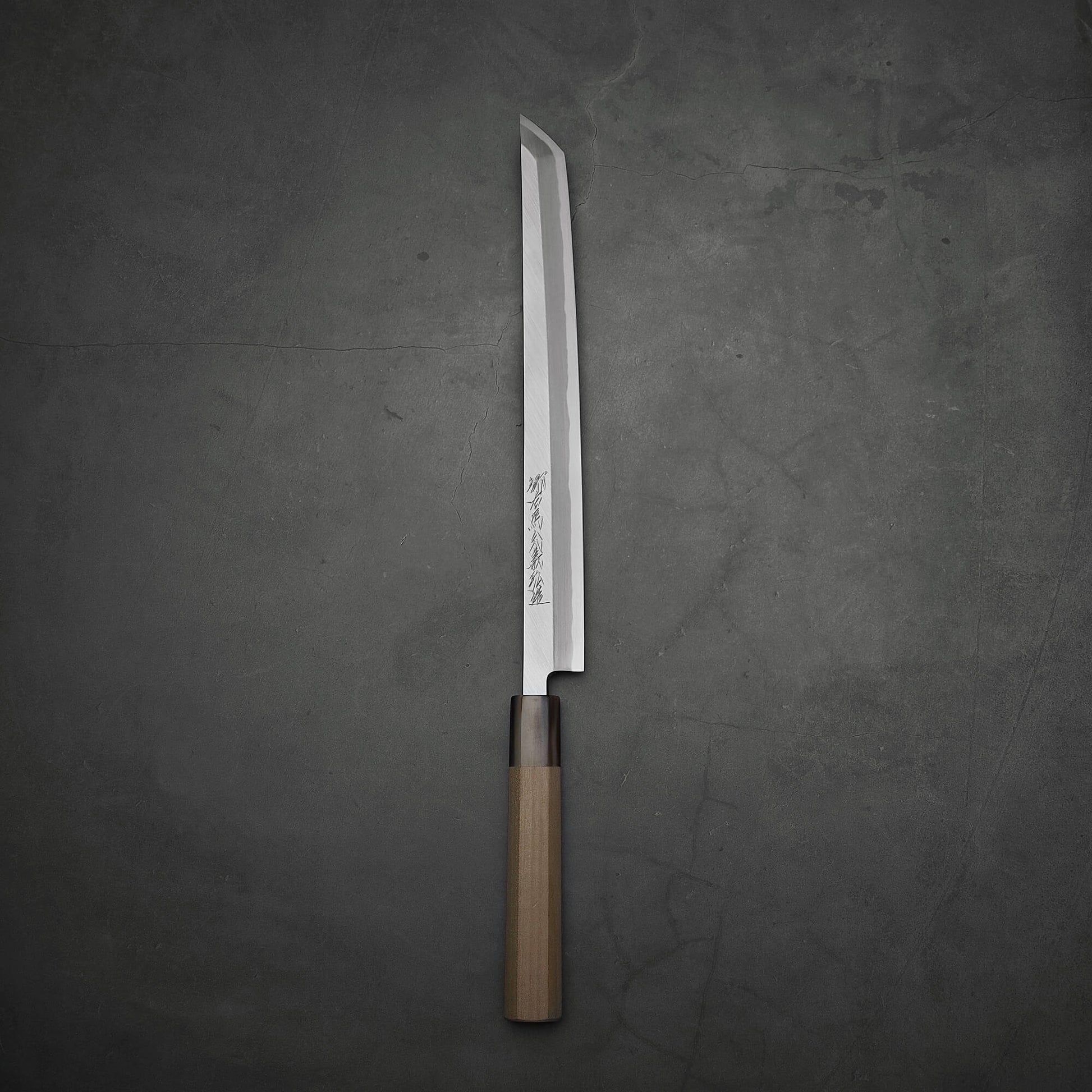 Top-down view of Yoshikazu Tanaka sakimaru takohiki knife with a hand-forged blade made of shirogami#2 steel.