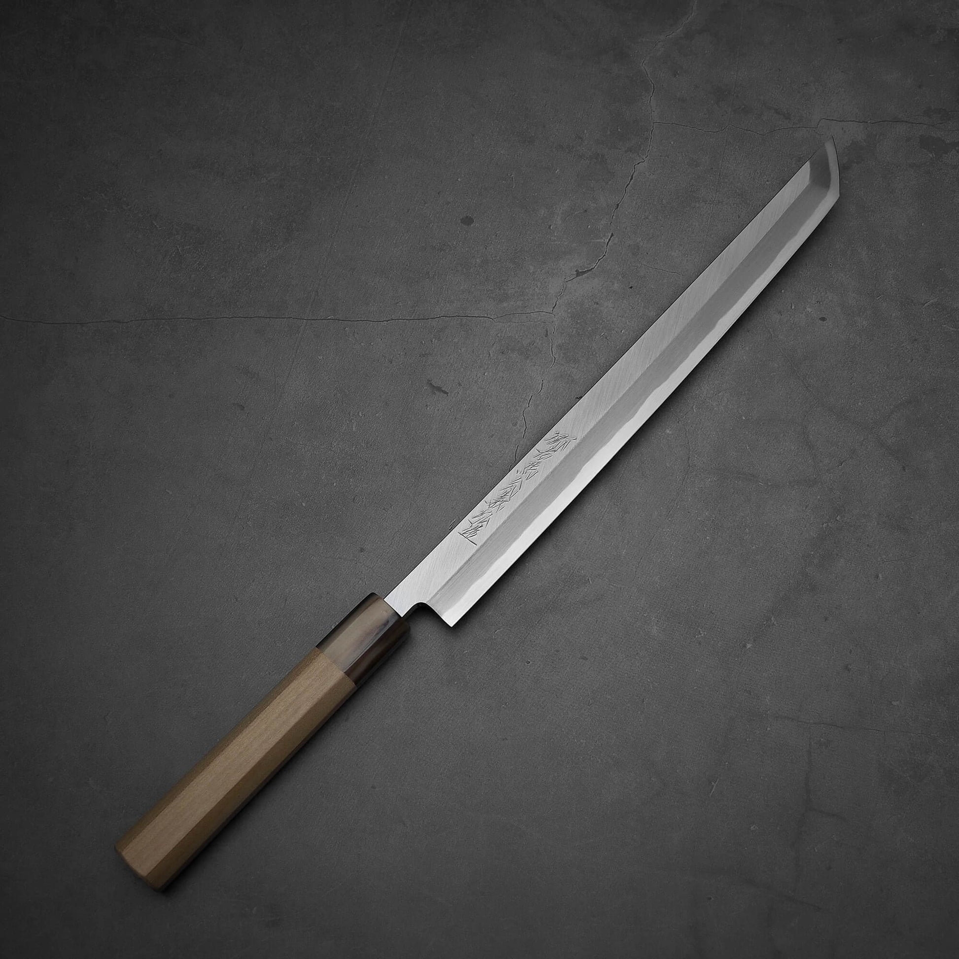 Top-down view of Yoshikazu Tanaka sakimaru takohiki knife with a hand-forged blade made of shirogami#2 steel.