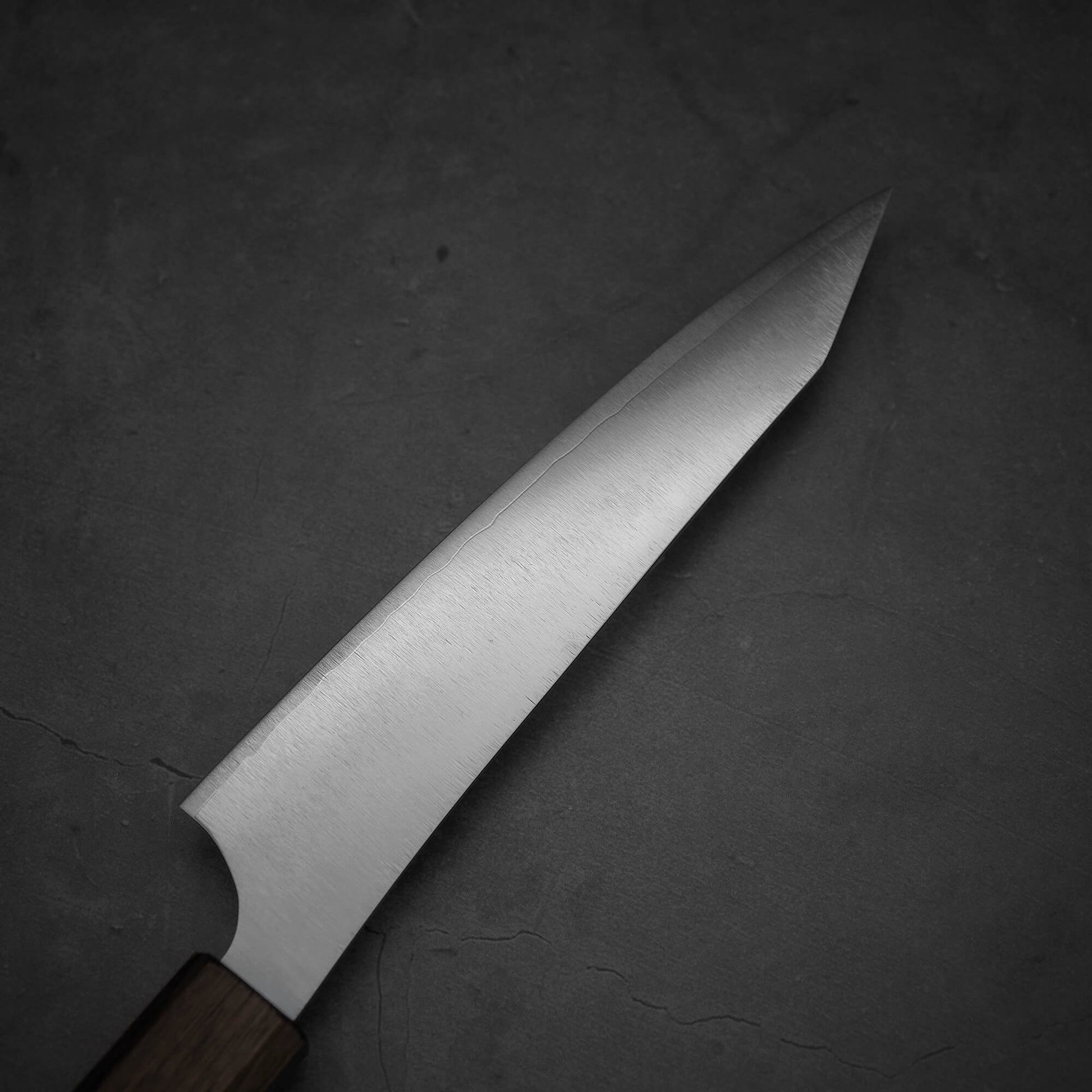 Top view of the blade of a Yu Kurosaki HAP40 Gekko petty knife. Image shows the left side of the blade.