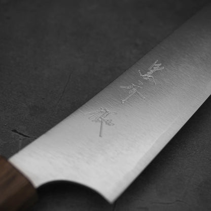 Close up view of the blade of a Yu Kurosaki HAP40 Gekko petty knife. Image focuses on the kanji side.