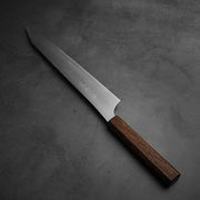 Top view of Yu Kurosaki HAP40 Gekko kiritsuke sujihiki 270mm in diagonal position. Kaji side is facing up. 