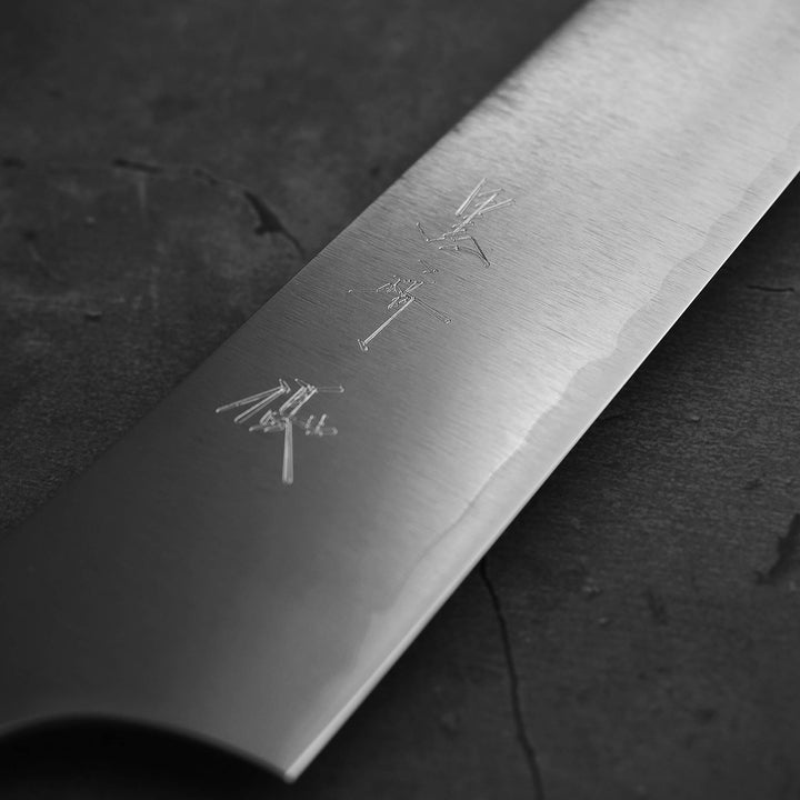 Close up view of Yu Kurosaki HAP40 Gekko kiritsuke sujihiki 270mm. Image focuses on the kanji side