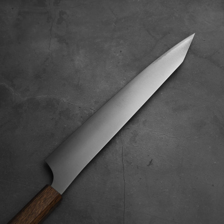 Top view of the blade of Yu Kurosaki HAP40 Gekko kiritsuke sujihiki 270mm. Image focuses on the left blade side.
