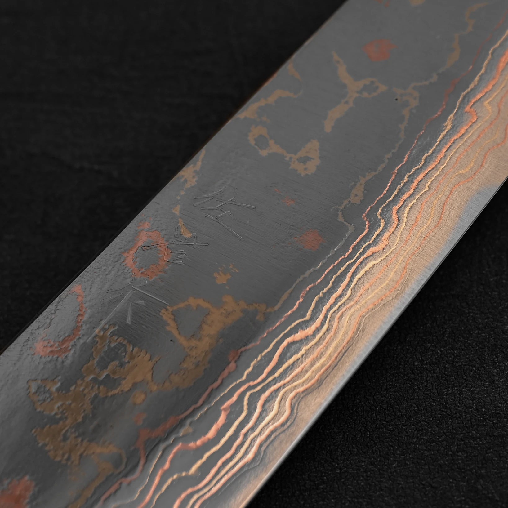 Close up of the kanji of Takeshi Saji rainbow damascus aogami#2 bunka knife