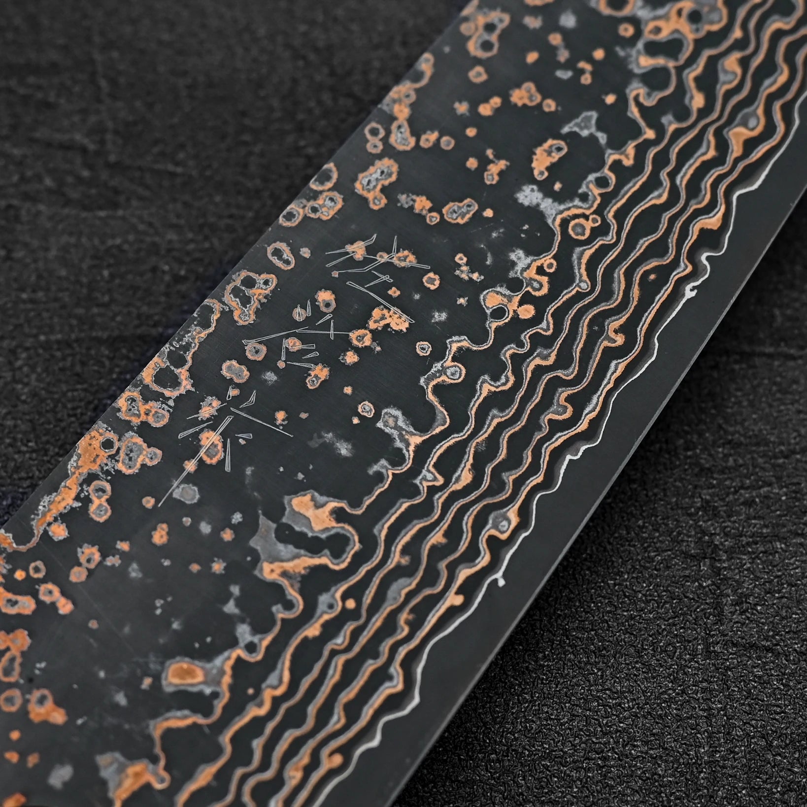 Close up view of the kanji of Takeshi Saji VG10 Gold damascus bunka knife