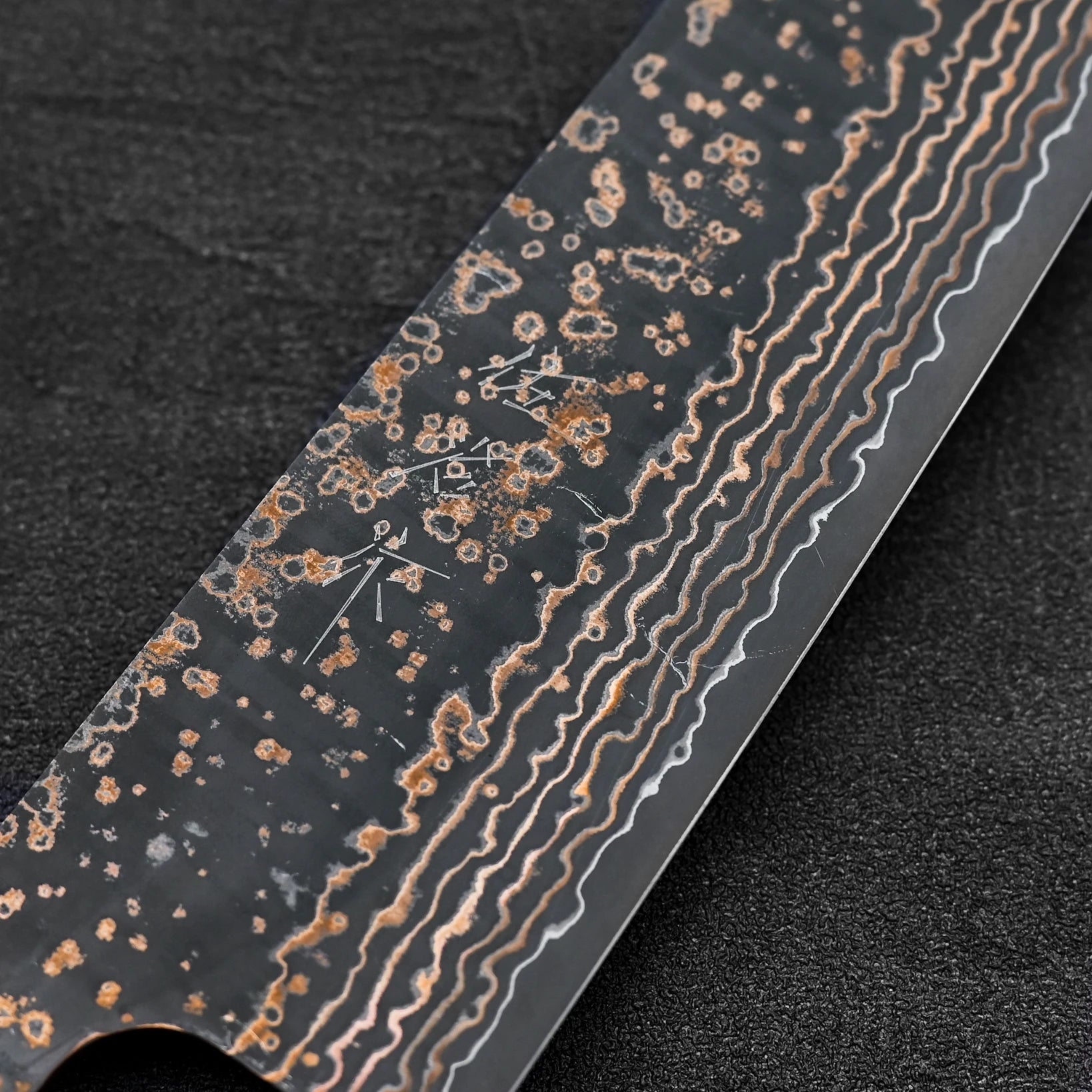 Close up of the kanji of Takeshi Saji VG10 Gold damascus gyuto knife