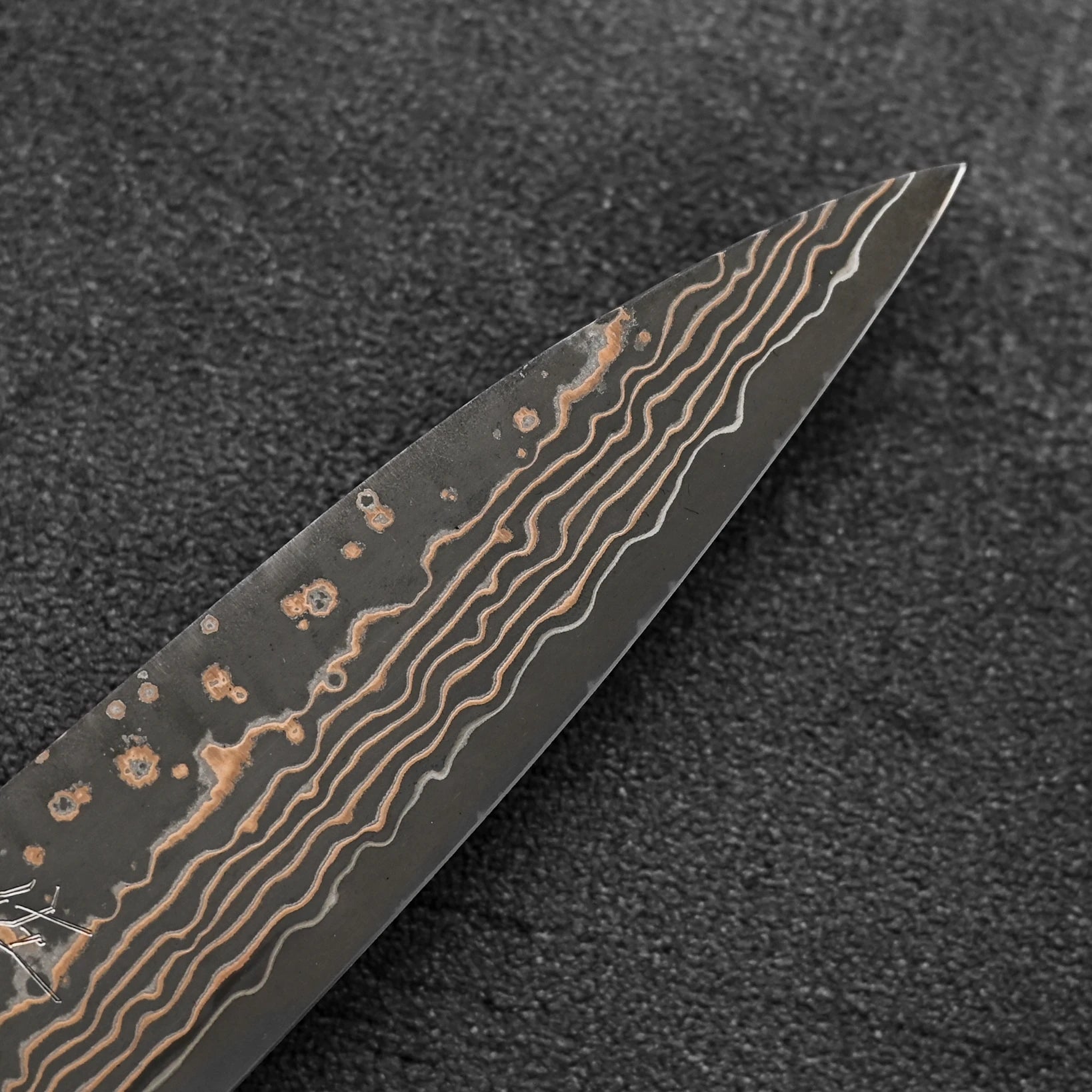 Close up of the tip area of Takeshi Saji VG10 Gold damascus petty knife
