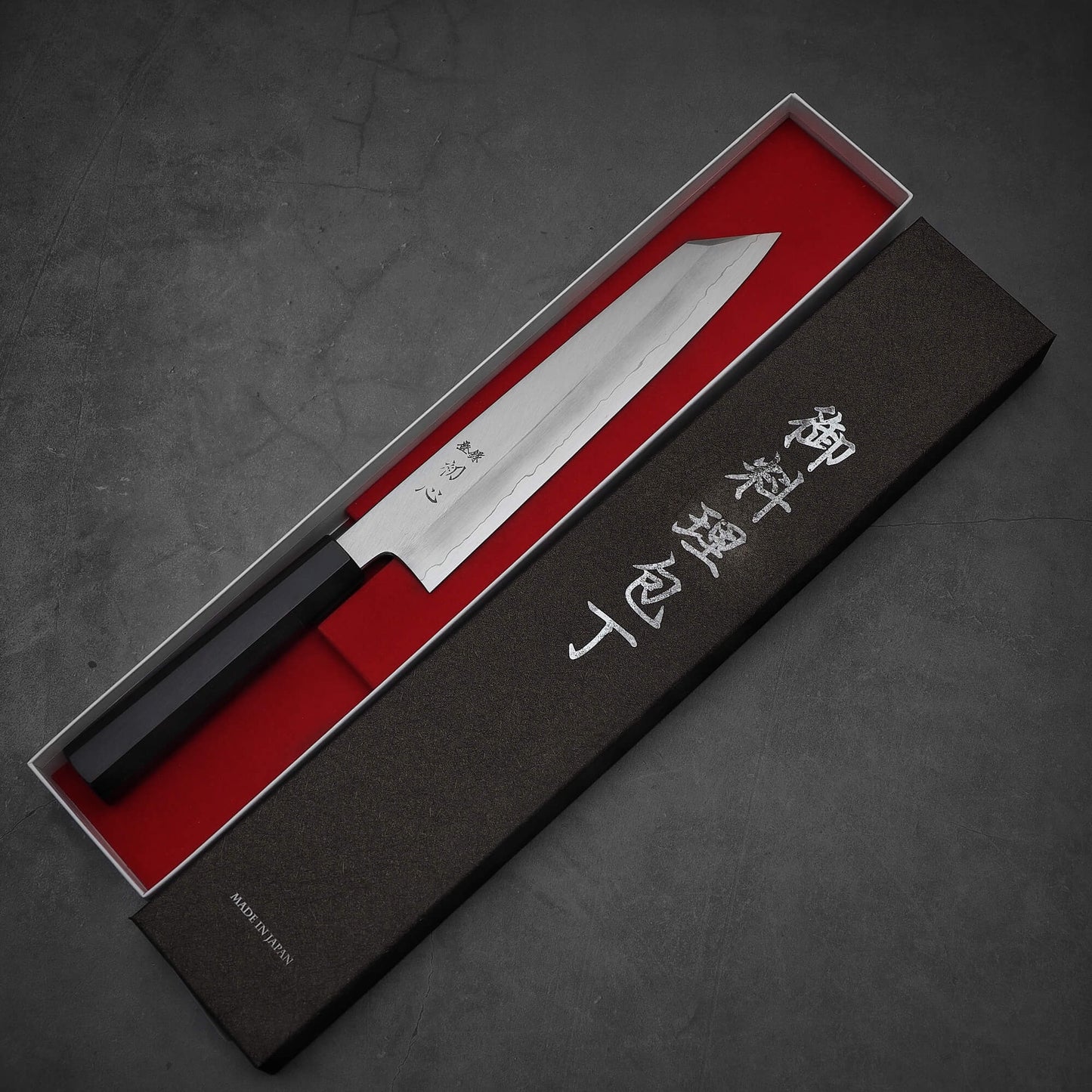 Top view of Hatsukokoro Nakagawa ginsan kiritsuke gyuto knife inside its box