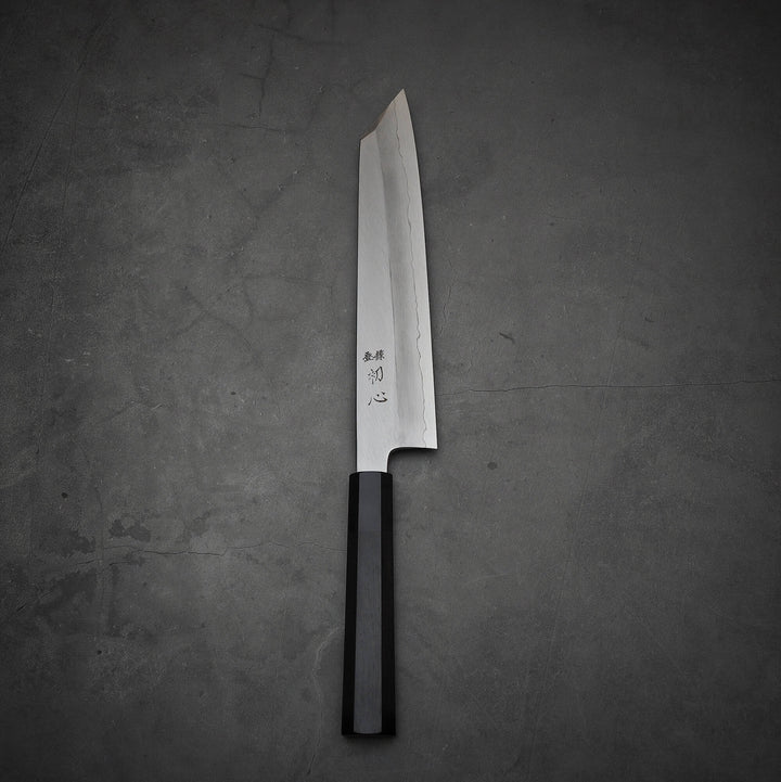 Top view of Hatsukokoro Nakagawa ginsan kiritsuke gyuto knife in vertical position