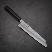 Top view of Hatsukokoro Nakagawa ginsan kiritsuke gyuto knife where pointed tip is facing towards lower right