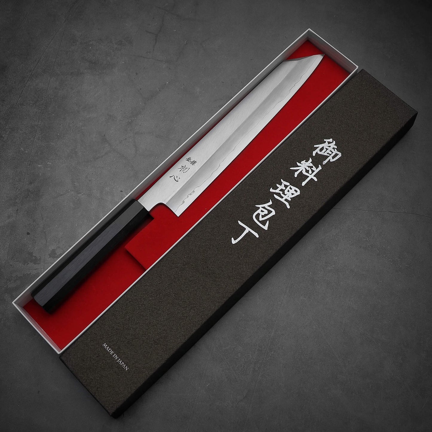 Top view of Hatsukokoro Nakagawa ginsan kiritsuke gyuto knife in its box