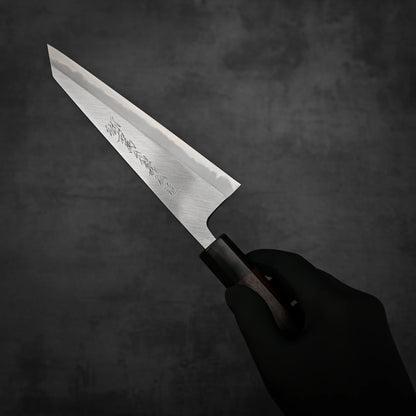 A hand holding a Yoshikazu Tanaka shirogami#1 double bevel honesuki knife