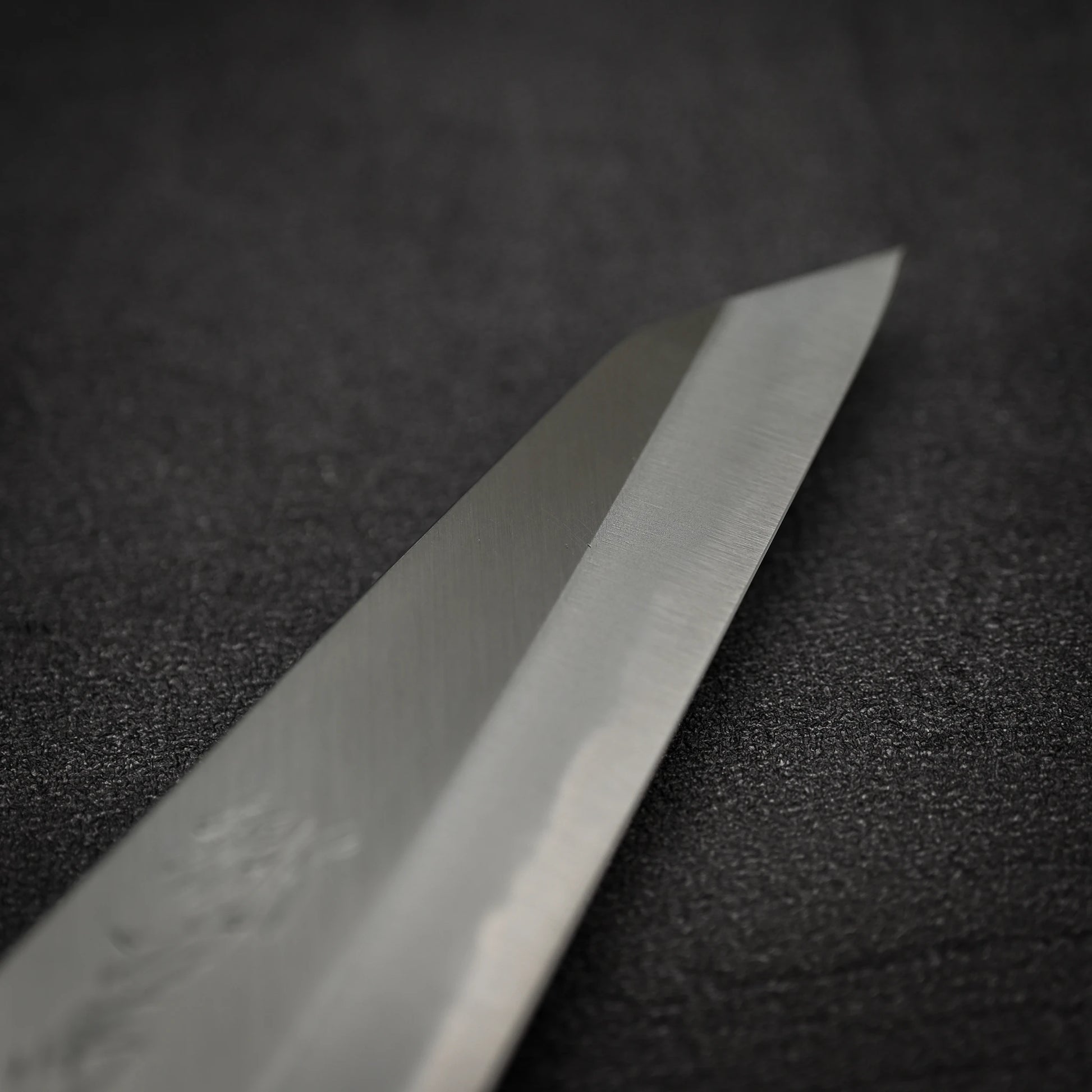 Close up view of the tip area of Yoshikazu Tanaka shirogami#1 double bevel honesuki knife