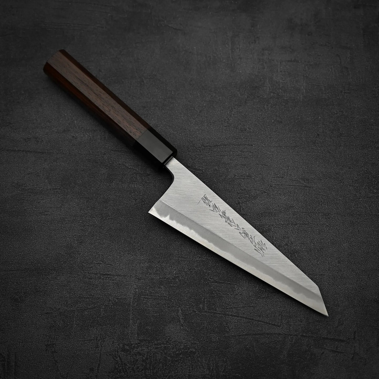 Top down view of Yoshikazu Tanaka shirogami#1 double bevel honesuki knife in diagonal position