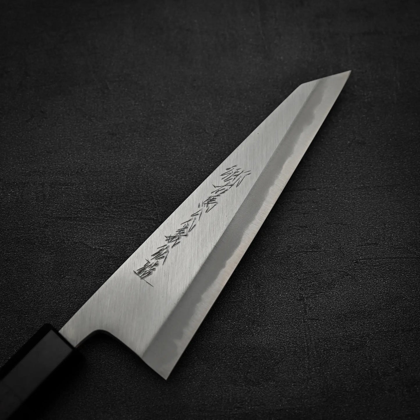 A close up view of the front blade of Yoshikazu Tanaka shirogami#1 double bevel honesuki knife